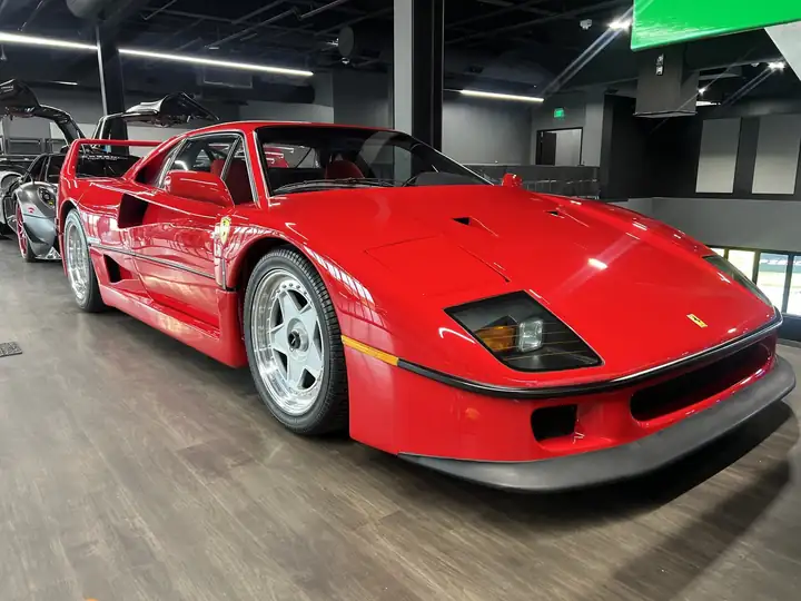 A red Ferrari F40 in a showroom, detailed by Brick's